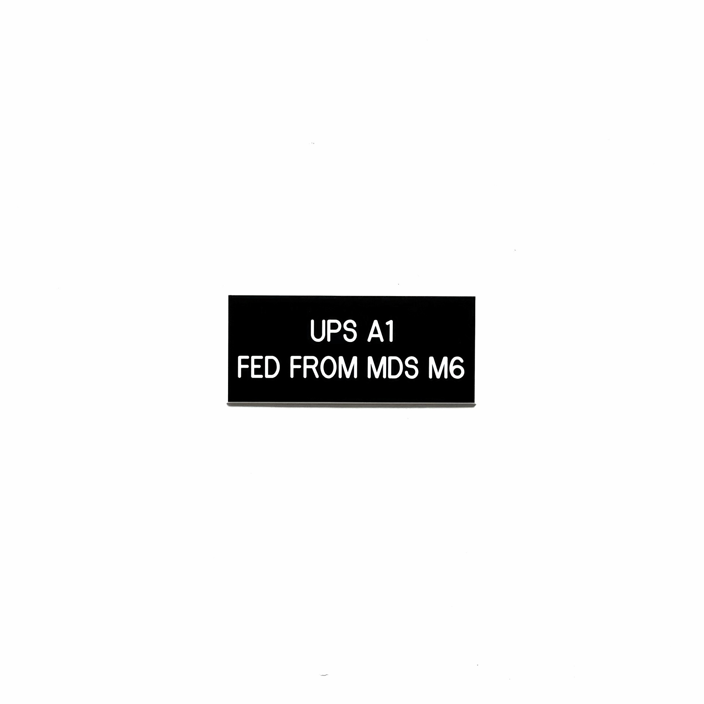 Engraved phenolic UPS identification label with main distribution source, data center power infrastructure, white on black