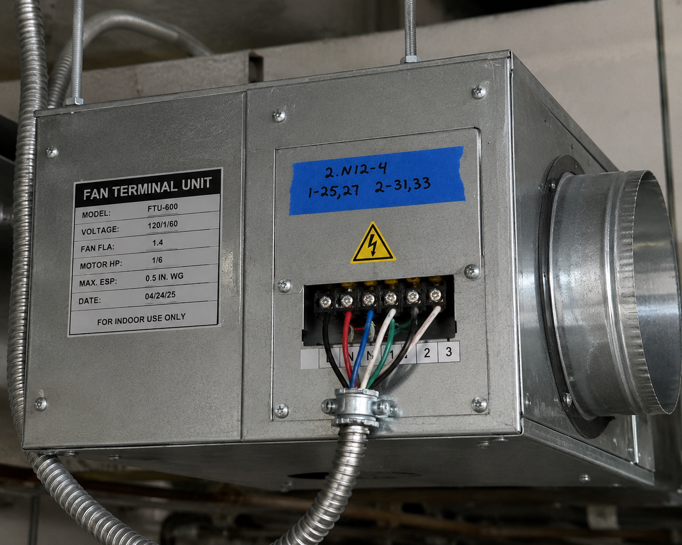 Fan terminal unit with temporary blue tape and marker identification — example of non-compliant jobsite labeling that fails inspection